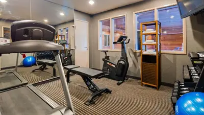 a gym with treadmills and ellipticals in a room at Best Western Plus Rama Inn & Suites in Oakdale