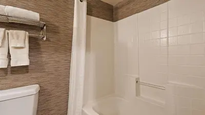 a bathroom with a tub and a toilet and a shower at Best Western Plus Rama Inn & Suites in Oakdale