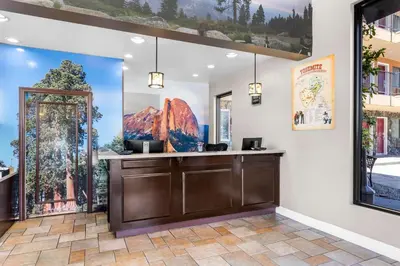 a room with paintings on the wall and a counter at Best Western Plus Yosemite Way Station in Mariposa