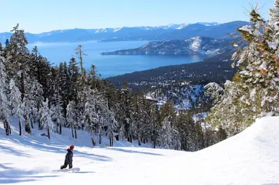 a person riding a snowboard down a snow covered slope at Creekside Retreat in Incline Village