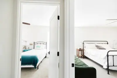 a bedroom with two beds and a mirror at Moon Ranch - a gateway to Yosemite in Mariposa