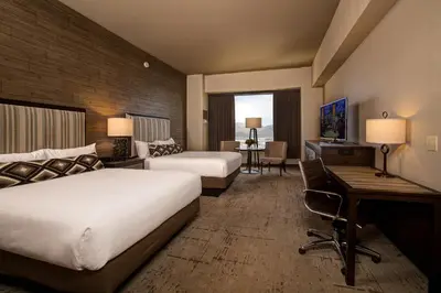 a hotel room with two beds and a desk at Nugget Casino Resort in Reno