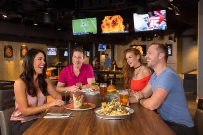 a group of people sitting around a table in a restaurant at Nugget Casino Resort in Reno