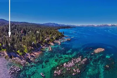 an aerial view of a lake with trees and water at Lv12: luxury villa walk to the Beach in Glenbrook
