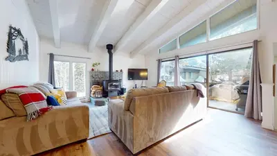 a living room with a couch and a fireplace at Chateau De Montagne #6 Condo in Mammoth Lakes