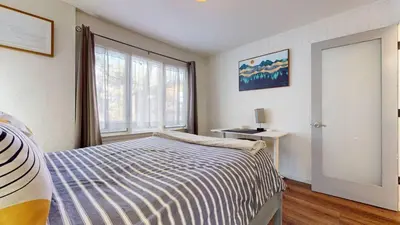 a bedroom with a bed and a large window at Chateau De Montagne #6 Condo in Mammoth Lakes
