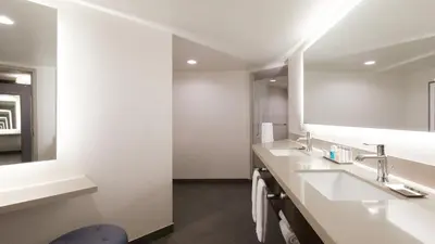 a bathroom with two sinks and a large mirror at Silver Legacy Reno, A Caesars Destination in Reno