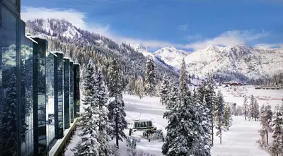 a snow covered mountain with a building and trees at Everline Resort and Spa, Lake Tahoe in Olympic Valley