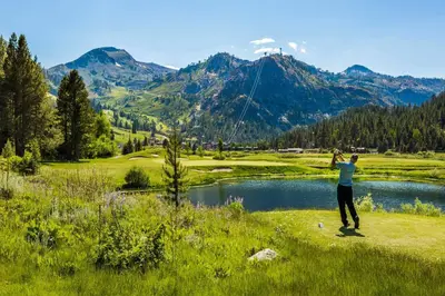 a man is flying a kite on a golf course at Everline Resort and Spa, Lake Tahoe in Olympic Valley