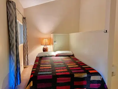 a small bedroom with a bed with a lamp on it at Mammoth Lakes Crestview Condo #50 in Mammoth Lakes