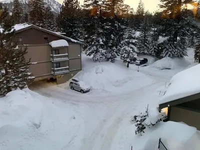 a house with a car parked in the snow at Mammoth Lakes Crestview Condo #50 in Mammoth Lakes