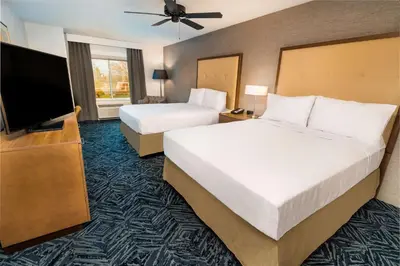 a hotel room with two beds and a flat screen tv at Homewood Suites By Hilton Rancho Cordova, Ca in Rancho Cordova