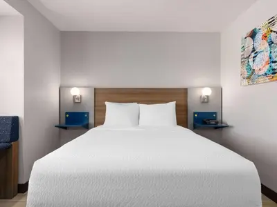 a bedroom with a large white bed and two lights at Microtel Inn & Suites by Wyndham Tracy in Tracy