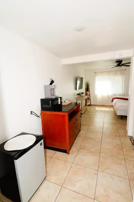 a living room with a table and a microwave at Sequoia Village in Three Rivers