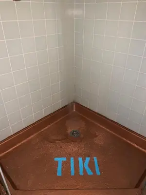 a tub in a bathroom with a blue sign on it at Tiki Lodge Hotel Modesto in Modesto