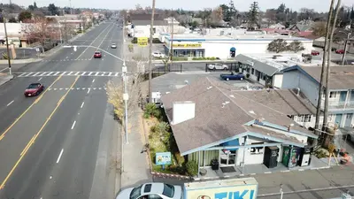 an aerial view of a town with a street at Tiki Lodge Hotel Modesto in Modesto