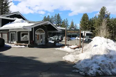 a building with a snow pile in front of it at Bluelake Inn @ Heavenly Village in South Lake Tahoe
