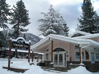 a building with a sign in the snow at Bluelake Inn @ Heavenly Village in South Lake Tahoe