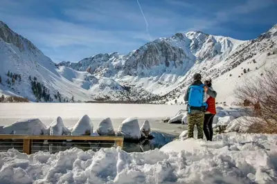 a man and a woman standing in the snow at Bigwood 13 in Mammoth Lakes