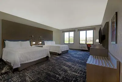 a hotel room with two beds and a television at Hampton Inn Patterson, Ca in Patterson