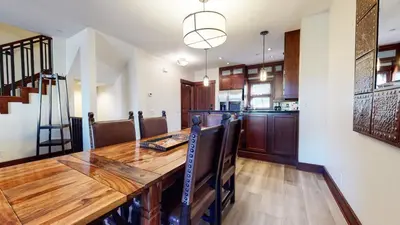 a kitchen and dining room with a wooden table at Juniper Crest #7 Condo in Mammoth Lakes