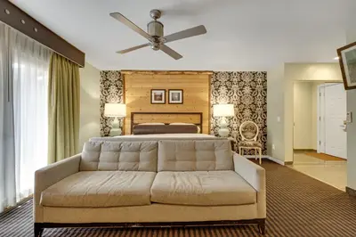 a bedroom with a bed and a couch at 3 Peaks Resort & Beach Club in South Lake Tahoe