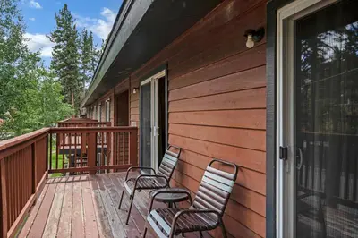 two chairs sitting on a deck on a house at 3 Peaks Resort & Beach Club in South Lake Tahoe