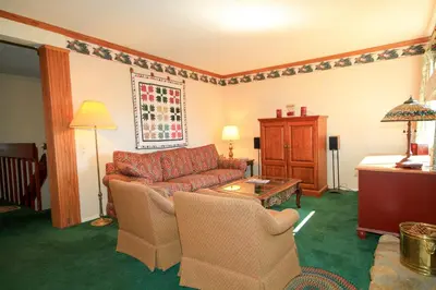 a living room with a couch and two chairs at Mammoth Ski Racquet Club 115 in Mammoth Lakes
