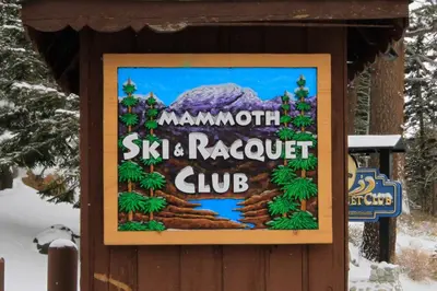 a sign for a ski resort club in the snow at Mammoth Ski Racquet Club 82 in Mammoth Lakes