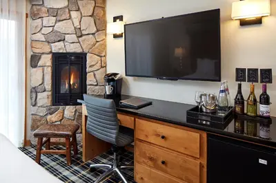 a room with a desk with a television and a fireplace at The Landing Resort and Spa in South Lake Tahoe