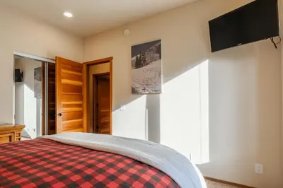 a bedroom with a bed and a flat screen tv at Snowcreek V 756 in Mammoth Lakes