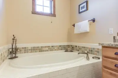 a white bath tub in a bathroom with a window at Lodges 1132 - 3 bedroom Townhome on Golf Course in Mammoth Lakes