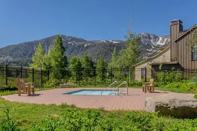 a pool with a slide and two benches in a yard at Lodges 1132 - 3 bedroom Townhome on Golf Course in Mammoth Lakes