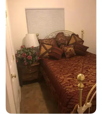 a bedroom with a bed and a table with a lamp at Sequoia National Forest CabinM in Panorama Heights