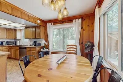 a kitchen with a wooden table and chairs at Casual and Cute Cabin Near the Lake in Tahoe Vista
