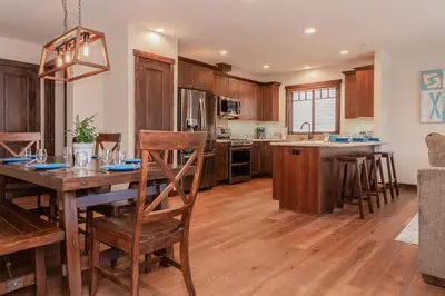 a kitchen with a wooden table and a dining room at Mountainside 4 in Mammoth Lakes