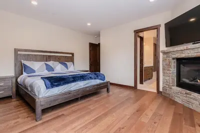 a bedroom with a bed and a fireplace at Mountainside 5 in Mammoth Lakes