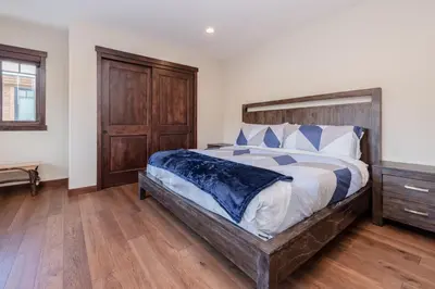 a bedroom with a large bed with a wooden headboard at Mountainside 5 in Mammoth Lakes