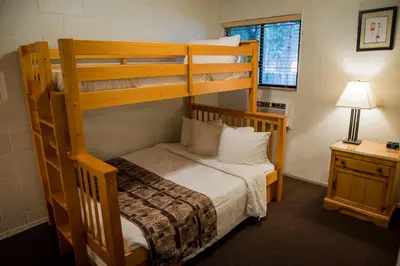 a bedroom with two bunk beds and a lamp at Big Pines Mountain House in South Lake Tahoe