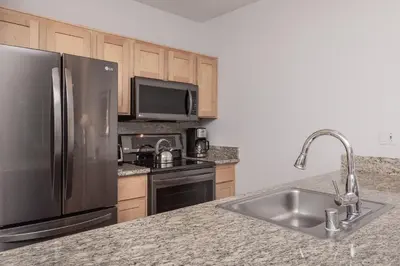 a kitchen with a stainless steel refrigerator and a sink at Juniper Springs Lodge #238 in Mammoth Lakes