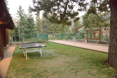 a ping pong table sitting in the grass in a yard at Juniper Springs Lodge #238 in Mammoth Lakes