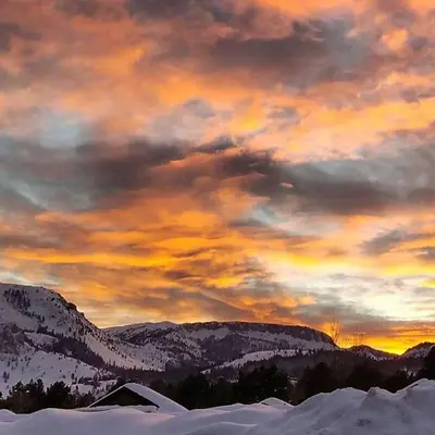 a painting of a sunset in the mountains with snow at Juniper Springs Lodge #238 in Mammoth Lakes