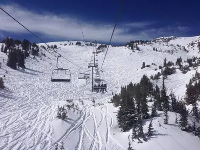 a ski lift on top of a snowy mountain at Juniper Springs Lodge #543 in Mammoth Lakes