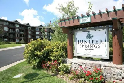 a sign for a hotel in front of a building at Juniper Springs Lodge #543 in Mammoth Lakes