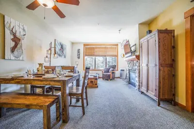 a dining room and living room with a table and chairs at White Mountain Lodge #2329 in Mammoth Lakes