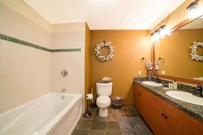 a bathroom with a tub and a toilet and a sink at White Mountain Lodge #2329 in Mammoth Lakes