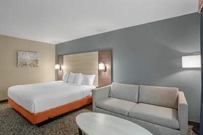 a hotel room with a bed and a couch at Best Western Porterville Inn in Porterville