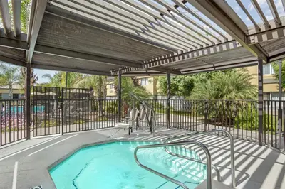 an outdoor swimming pool with a pergola at Best Western Porterville Inn in Porterville