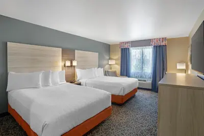 a hotel room with two beds and a desk at Best Western Porterville Inn in Porterville