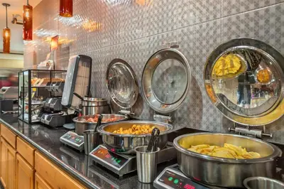 a kitchen with many pots and pans of food at Best Western Plus Sonora Oaks Hotel and Conference Center in Sonora
